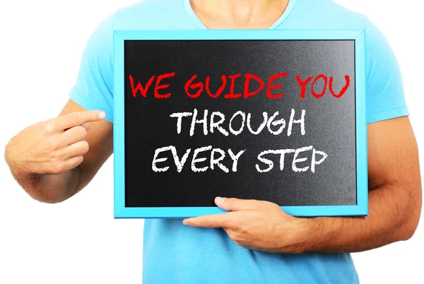 Man holding blackboard in hands and pointing the word — Stock Photo, Image