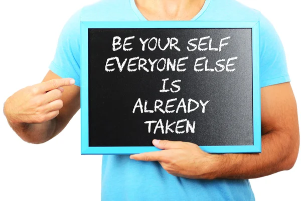 Man holding blackboard in hands and pointing the word BE YOUR SE — Stock Photo, Image