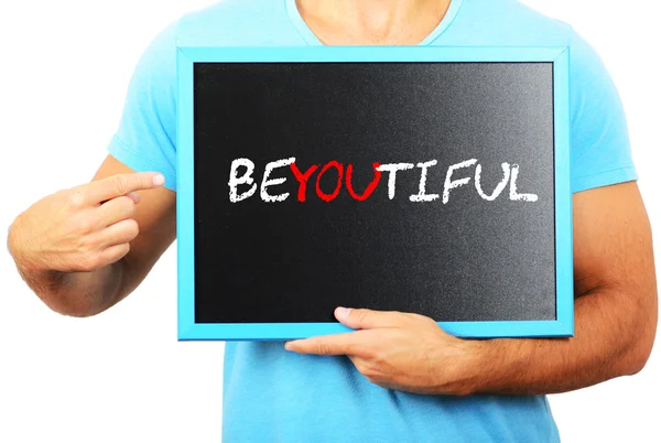 Man holding blackboard in hands and pointing the word BEYOUTIFUL — Stock Photo, Image