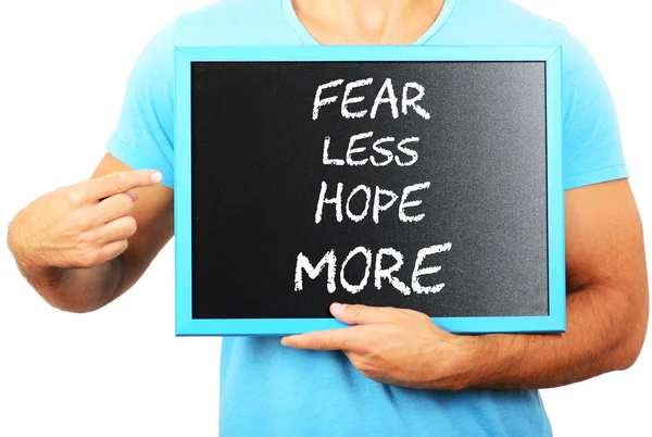 Man holding blackboard in hands and pointing the word FEAR LESS — Stock Photo, Image
