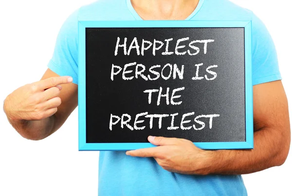 Man holding blackboard in hands and pointing the word HAPPIEST P — Stock Photo, Image