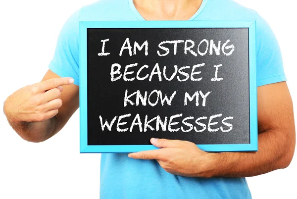 Man holding blackboard in hands and pointing the word I AM STRON — Stock Photo, Image