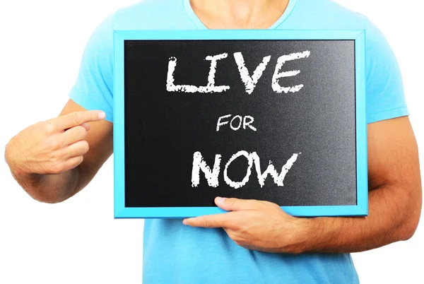 Man holding blackboard in hands and pointing the word LIVE FOR N — Stock Photo, Image