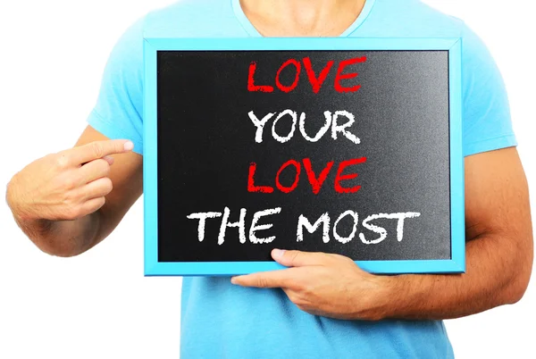 Man holding blackboard in hands and pointing the word LOVE YOUR — Stock Photo, Image