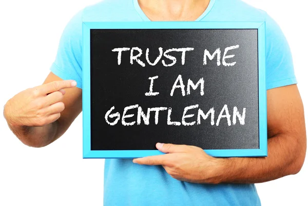 Man holding blackboard in hands and pointing the word TRUST ME I — Stock Photo, Image