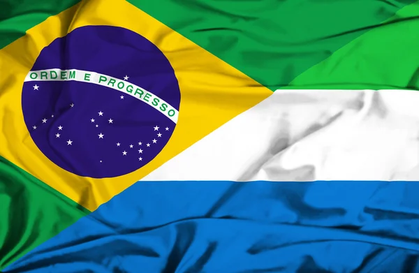 Waving flag of Sierra Leone and Brazil — Stock Photo, Image