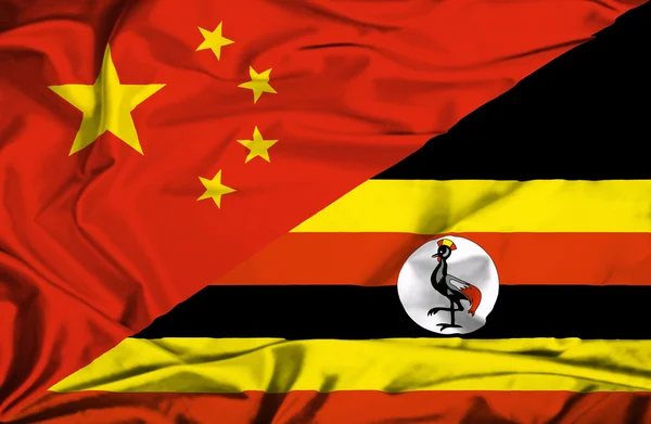 Uganda ve Nikon bayrağı sallayarak — Stok fotoğraf