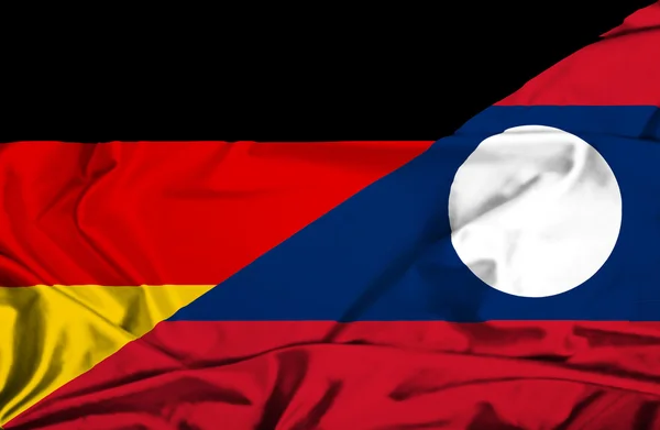 老挝和德国那飘扬的旗帜 — 图库照片