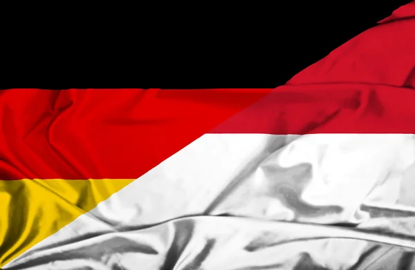 Waving flag of Monaco and Germany — Stock Photo, Image