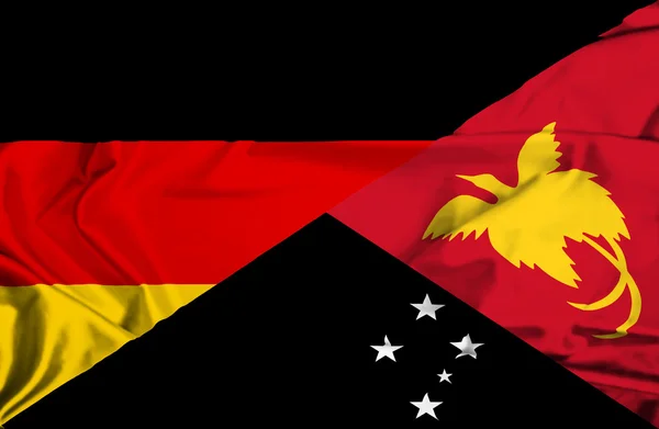 Waving flag of Papua New Guinea and Germany — Stock Photo, Image