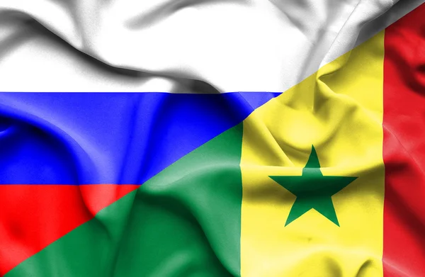 Waving flag of Senegal and Russia — Stock Photo, Image