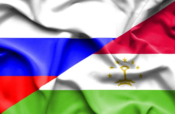 Waving flag of Tajikistan and Russia — Stock Photo, Image