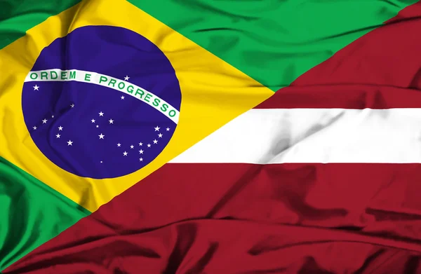 Bandeira acenando da Letônia e Brasil — Fotografia de Stock