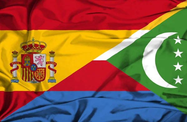 Vlající vlajka komor a Španělsko — Stock fotografie