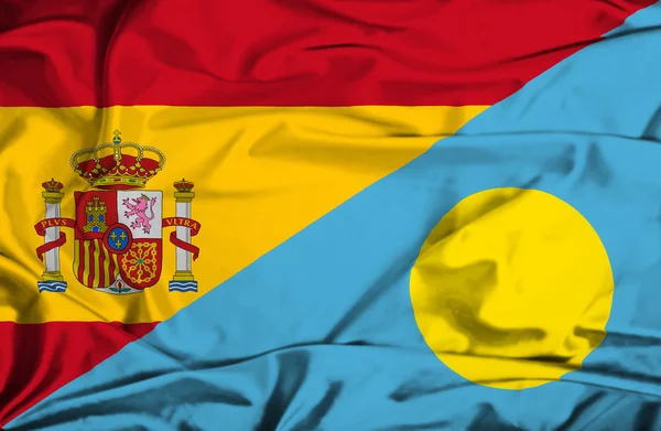 Waving flag of Palau and Spain — Stock Photo, Image