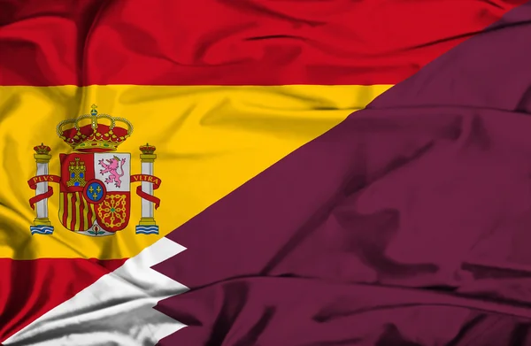 Waving flag of Qatar and Spain — Stock Photo, Image