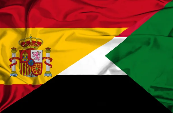 Fahne von Sudan und Spanien schwenkend — Stockfoto