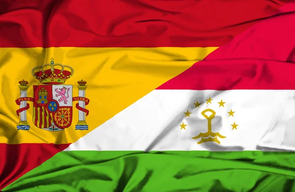 Waving flag of Tajikistan and Spain — Stock Photo, Image