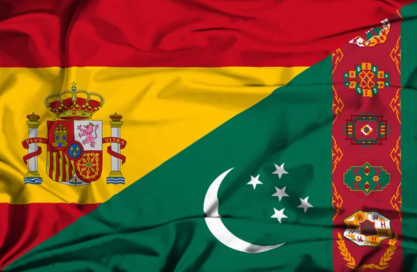 Waving flag of Turkmenistan and Spain — Stock Photo, Image