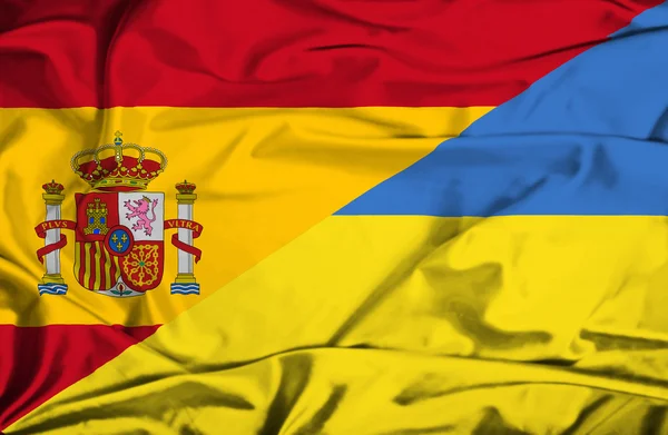 Waving flag of Ukraine and Spain — Stock Photo, Image