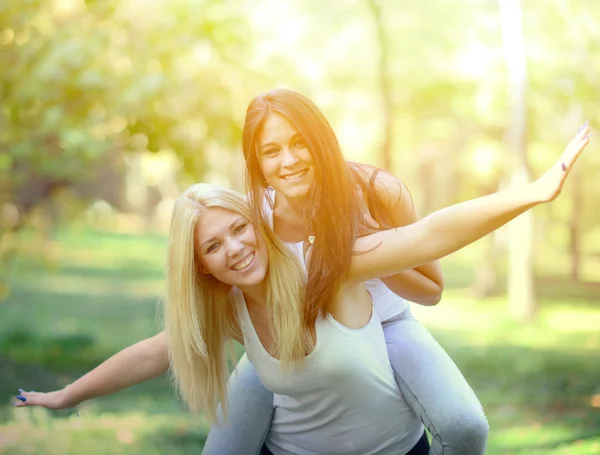 Dwie dziewczyny szczęśliwy, zabawy w parku — Stockfoto