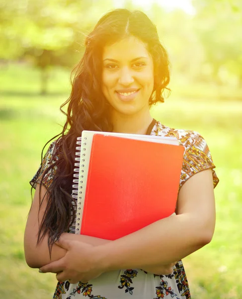 Portrait of happy student girl holding books outdoor — Stock Photo, Image