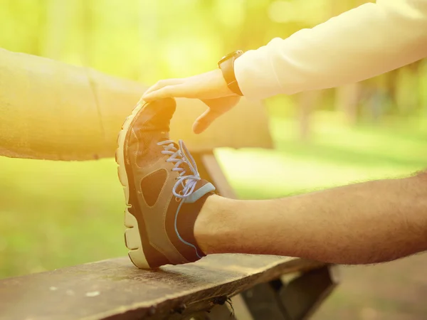 Handsome sportsman stretching outdoors — Stock Photo, Image