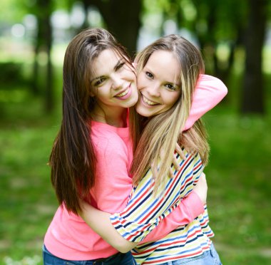 İki genç kız arkadaş Park'ta bir kucaklama