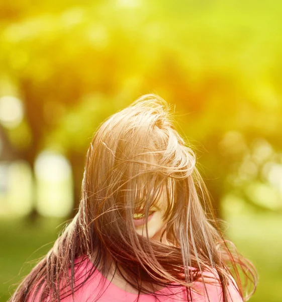 Hair covers woman face while jumping — Stock Photo, Image