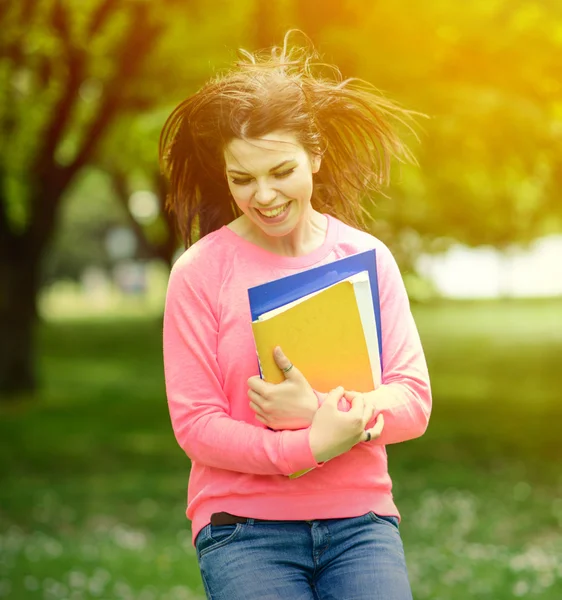 Happy student girl jumping for joy after passed exam — Stock Photo, Image