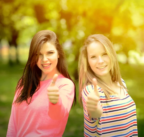 Meninas jovens mostrando polegares para cima — Fotografia de Stock
