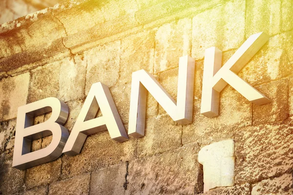 Bank sign carved in stone on building — Stock Photo, Image