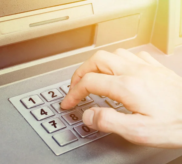 Hand entering PIN numbers on ATM bank machine — Stock Photo, Image