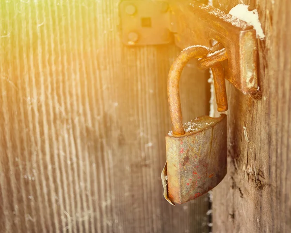 Old padlock on wooden door — Stock Photo, Image