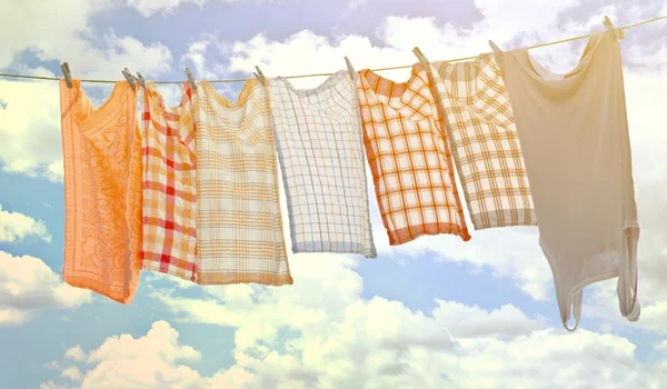 Laundry hanging over sky Stock Picture