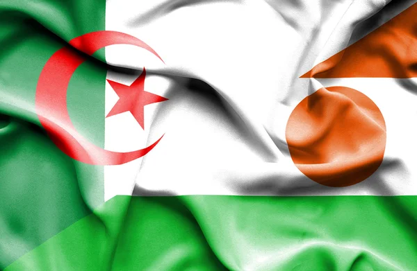 Waving flag of Niger and Algeria — Stock Photo, Image