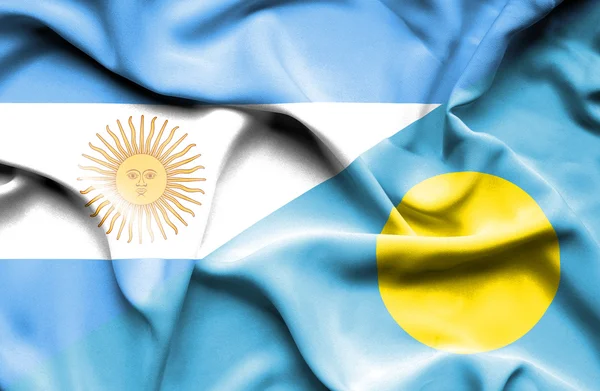 Waving flag of Palau and Argentina — Stock Photo, Image