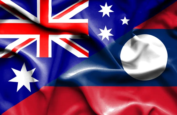 Waving flag of Laos and Australia — Stock Photo, Image