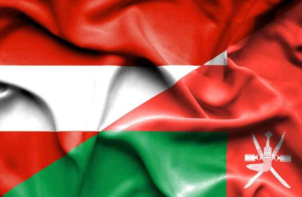 Waving flag of Oman and Austria — Stock Photo, Image