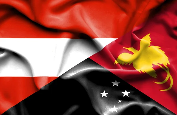 Vlající vlajka Papuy-Nové Guineje a Rakouska — Stock fotografie