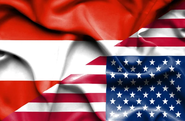 Macha flagą Stanów Zjednoczonych i Austria — Zdjęcie stockowe