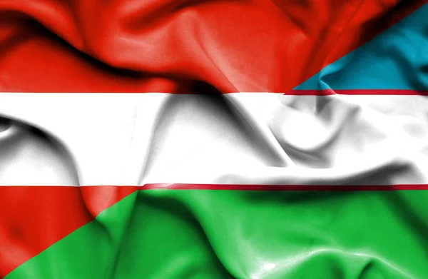 Bandeira ondulada do Uzbequistão e da Áustria — Fotografia de Stock