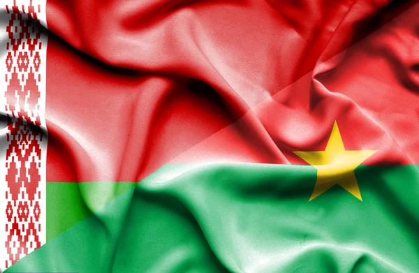 Burkina Faso és Fehéroroszország hullámzó zászlaja — Stock Fotó