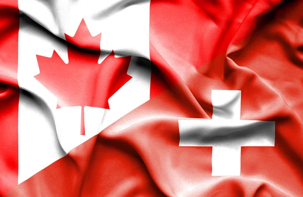 Waving flag of Switzerland and Canada — Stock Photo, Image