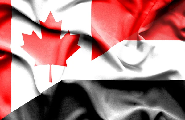 Waving flag of Yemen and Canada — Stock Photo, Image