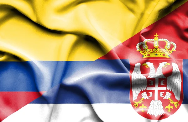 Szerbia és a Columbia hullámzó zászlaja — Stock Fotó
