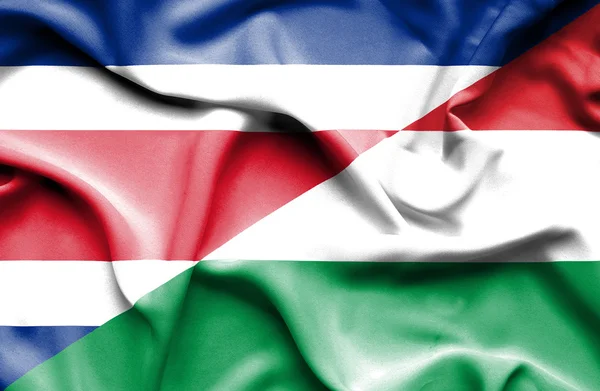 Waving flag of Hungary and Costa Rica — Stock Photo, Image