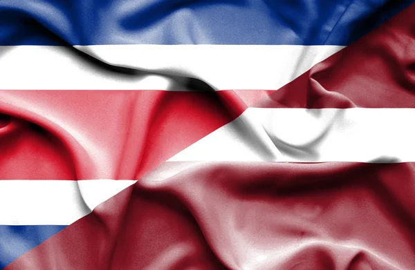 Waving flag of Latvia and Costa Rica — Stock Photo, Image