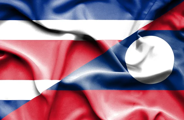 Waving flag of Laos and Costa Rica — Stock Photo, Image