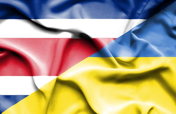 乌克兰和哥斯达黎加那飘扬的旗帜 — 图库照片